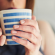 Woman sipping from warm mug